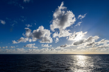 Seascape, blue sea. Sunset at sea. Calm weather. View from cargo vessel. Work at sea. Commercial shipping.