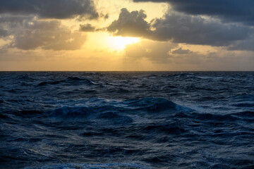 Beautiful seascape - waves and sky with clouds with beautiful lighting. Golden hour.