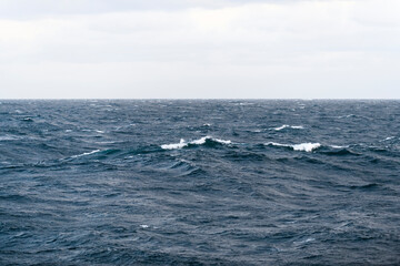 Seascape, blue sea. Windy weather. View from vessel. Waves at sea. Storm.
