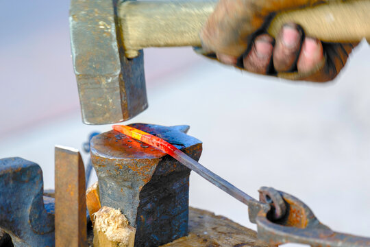 the hammer strikes the red-hot iron