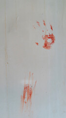 bloody handprints on a white wall. crime concept © denis