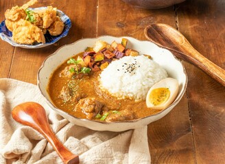 Signature Beef Spice Curry rice in a bowl on wooden table top view of Thai food
