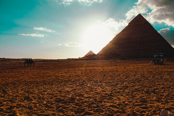 View of the giza pyramid in cairo egypt. One large one in the foreground and a small one in the distance. - obrazy, fototapety, plakaty