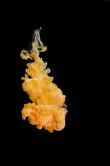 beautiful yellow gold mother-of-pearl clear ink abstract clouds in water isolated on black...