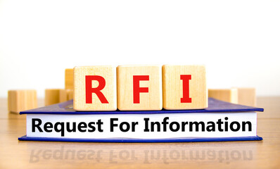 RFI request for information symbol. Concept words RFI request for information on wooden cubes on book on a beautiful white background. Business RFI request for information concept. Copy space.