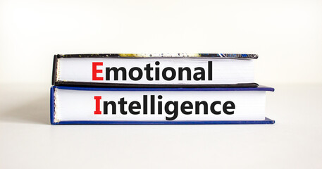 EI emotional intelligence symbol. Concept words EI emotional intelligence on books on a beautiful white table white background. Business EI emotional intelligence concept, copy space.