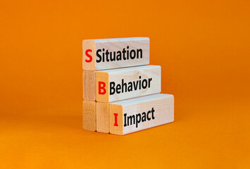 SBI situation behavior impact symbol. Concept words SBI situation behavior impact on blocks on a...