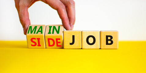 Extra or side job symbol. Businessman turns wooden cubes and changes concept words Side job to Main...