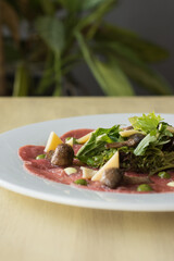 TTenderloin carpaccio with parmesan cheese and salad. Raw meat