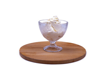 portion of ice cream in a crystal glass on a wooden board