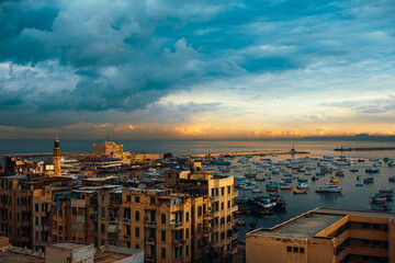 View of the Alexandria port at sunrise, golden blue sky. Amazing view of hundreds of little fishing...