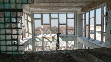 war. building after the bombing. destroyed building. old abandoned building. Old stairs of an abandoned house. old room interior