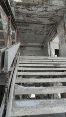 war. building after the bombing. destroyed building. old abandoned building. Old stairs of an abandoned house. old room interior