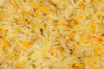 Sauerkraut with carrot served as a salad, full-frame background, top view. National dishes in Germany
