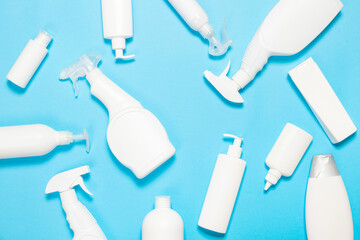 white bottles of cleaning agent on a blue background on the side. Professional cleaning products, general cleaning. Household chemicals top view