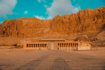 Foto op Plexiglas Closer view of the amazing hatshepsut temple near luxor egypt. Single road leading to the huge temple in the mountain. Empty during early morning hours © Antonio