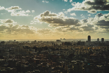 Amazing panorama of the huge Cairo city, great pyramids of Giza visible in the distance. Cloudy...