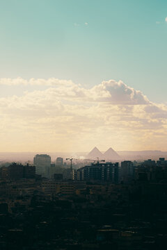 Vrtical shot of the great Giza pyramids in the distance, seen from Salah Al Din castle area. Huge city overshadowed by the amazing distant landmark