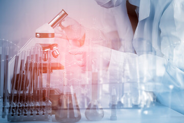 biochemical research scientist working with a microscope for the virus,Doctor man write a history of the experimental results in a , laboratory glassware containing chemical liquid for design.