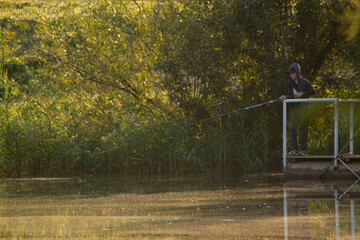 At dawn, a boy, in a tracksuit, is fishing on a pontoon. Banner, cover, flyer, layout design.
Omsk, Omsk Oblast, Russia


