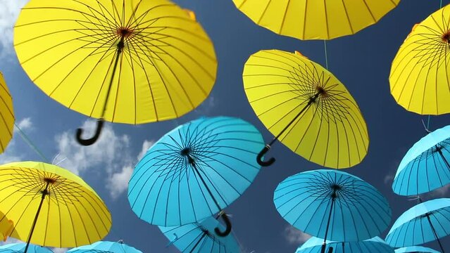 Lots of colorful umbrellas in the sky. City decoration