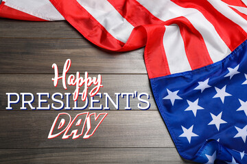 Fototapeta na wymiar Happy President's Day - federal holiday. American flag and text on wooden background, top view