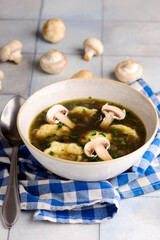 Mushroom broth with dumplings and champignons