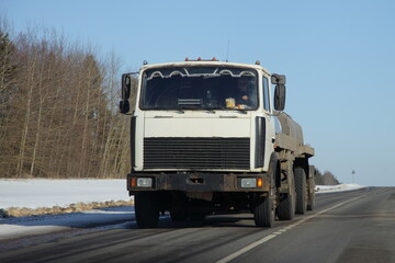 Fototapeta na wymiar Barrel truck on winter road in Russia. Front view. Liquid cargo transportation logistics.
