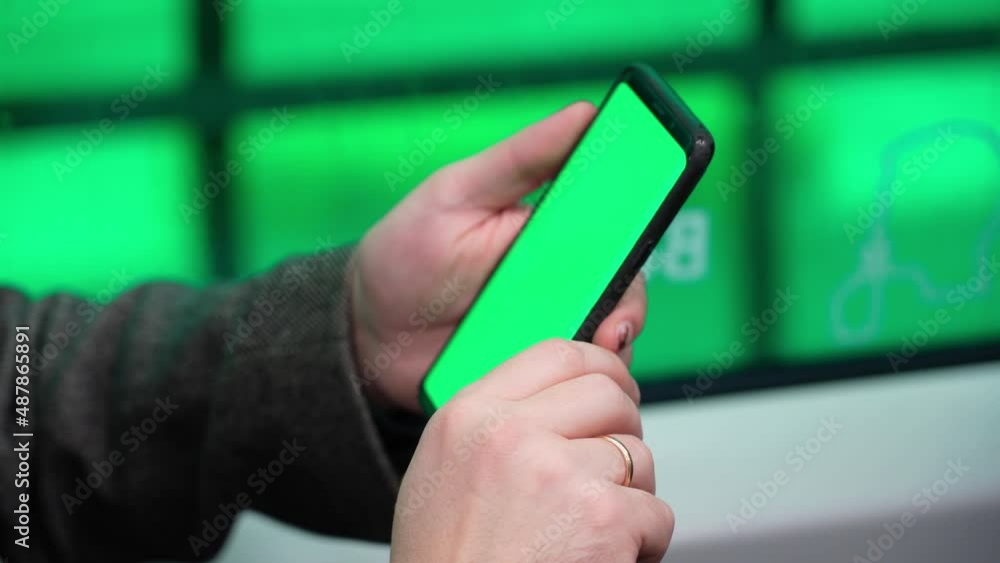 Poster close view of man watch smart phone with green screen and browsing online in train. mock up for watc