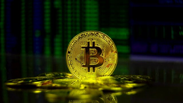 Pile of bitcoins with computer hacking background. Crypto currency block chain operations, future of money