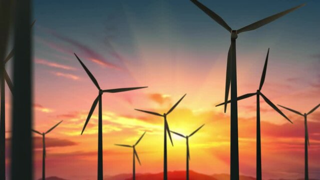 Wind turbines farm at beautiful orange sunset. Ecologic energy generators on beautiful sunny mountain landsape. Green power generation concept.