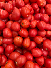 large pile of small red tomatoes