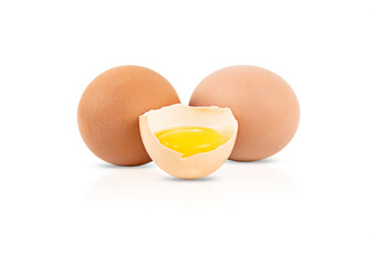 One broken egg and two whole eggs isolated on a white background