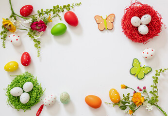 Easter flat lay. Egg nest, flower and decoration white background, overhead, copy space.