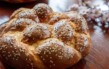 Easter sweet bread, greek tsoureki, brioche braid on wooden table, close up overhead