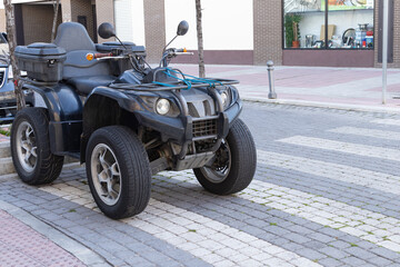 ATV Quad bike of black color parked on the street