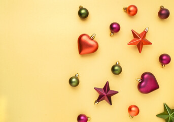 Bright Christmas pattern with balls, stars and hearts on gold background. Flat lay, banner format