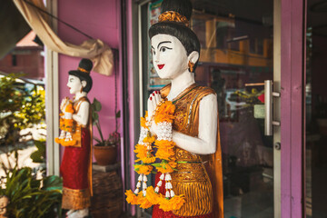 Decorative woman figures at the entrance of Thai massage saloon in Bangkok, Thailand
