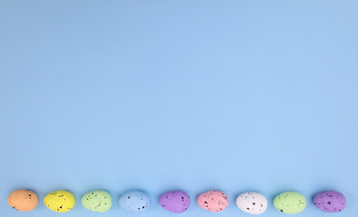 Fototapeta na wymiar Easter creative concept with eggs on pastel bright blue background. Flat lay minimal copy space. Creative spring holidays background