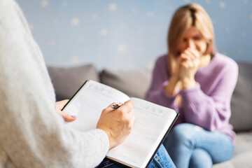 Psychotherapy session, a woman is talking with her psychologist at her office. Psychotherapy...