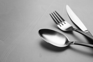 Set of cutlery on grey table, closeup. Space for text