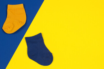 World Down Syndrome Day background. Down syndrome symbol odd socks on yellow and blue background....