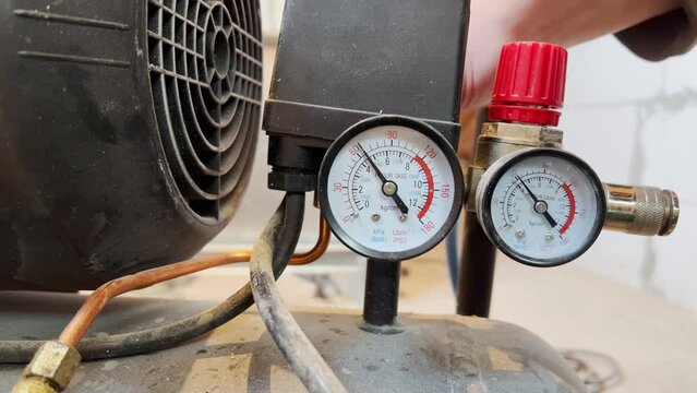 Pressure relief in the air compressor. Process control on a manometer.Close-up.