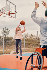 Young woman enjoys in basketball game with her disabled friend on outdoor court.