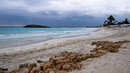 Fototapeta na wymiar Idyllic empty golden sandy beach. Nissi bay beach in winter, Ayia Napa, Cyprus