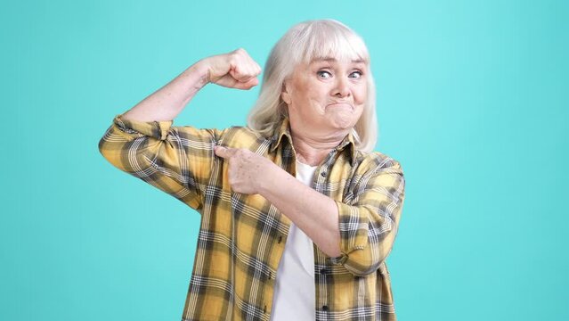 Sporty grandma train gym demonstrate triceps isolated cyan color background