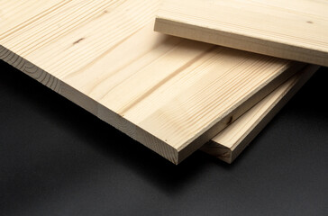 Planks piled on a black background.
