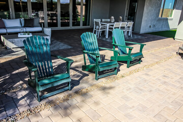 Fototapeta na wymiar Back Yard Patio With Three Retro Green Lawn Chairs