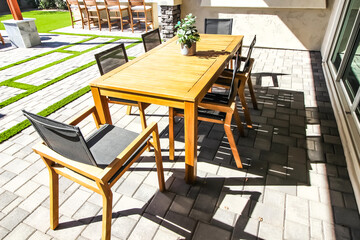 Wooden Patio Table And Six Chairs On Pavers