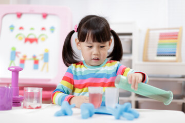 young girl pretend playing food preparing at home